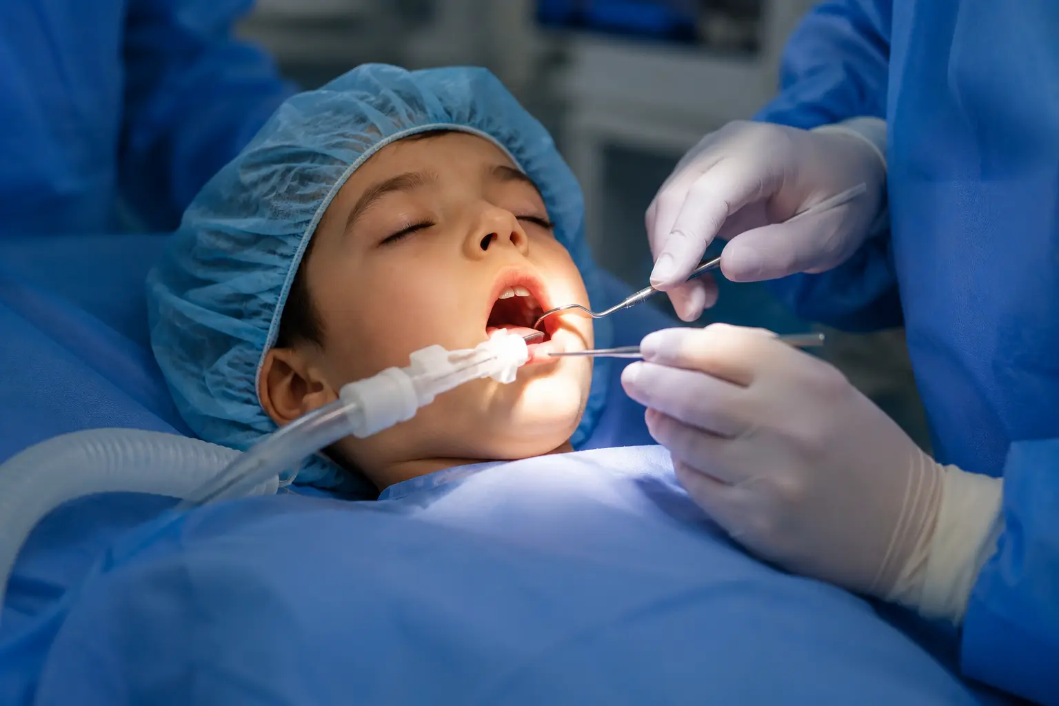 Child lying in a hospital operating room before tonsil and adenoid surgery